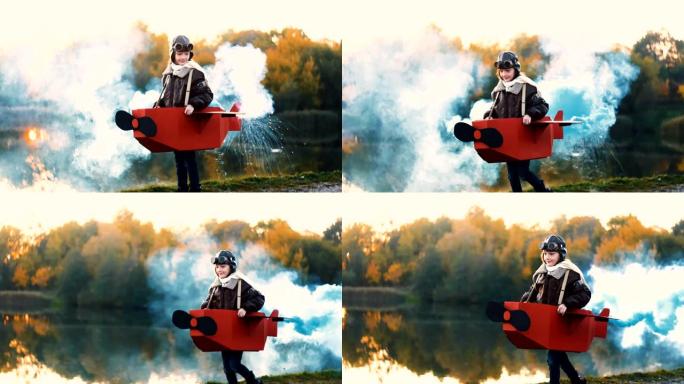 快乐的小飞行员女孩在有趣的纸板飞机上沿着日落湖奔跑，彩色烟雾扮演飞行员慢动作