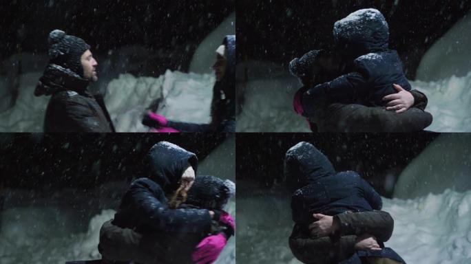 在冬天的夜晚，雪从天而降，一对夫妇亲吻并拥抱着爱情的魔力。