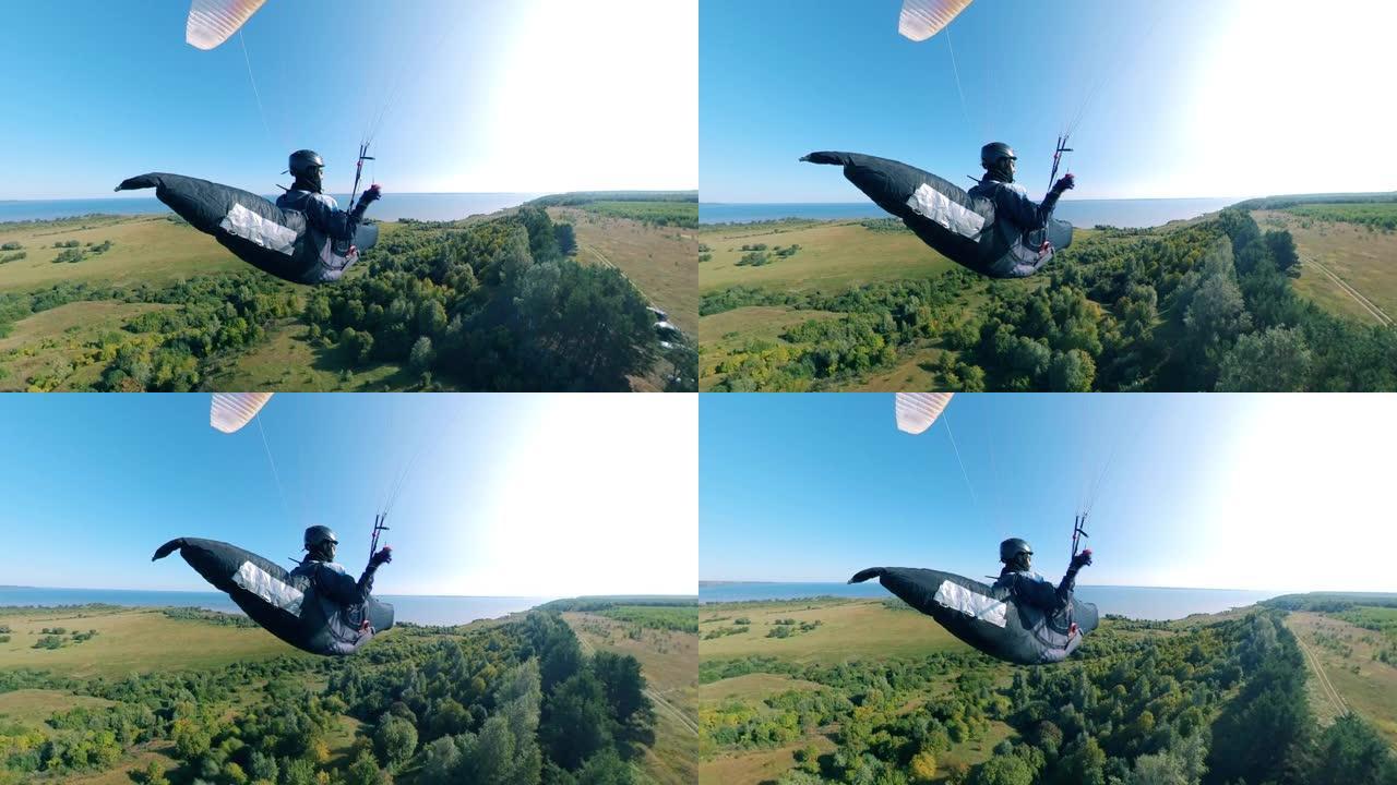 滑翔伞在一个人持有的土地上飞行