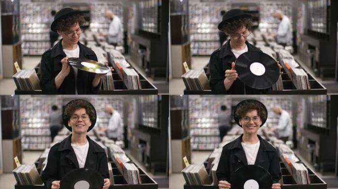 女性音乐商店老板与黑胶唱片合影并微笑