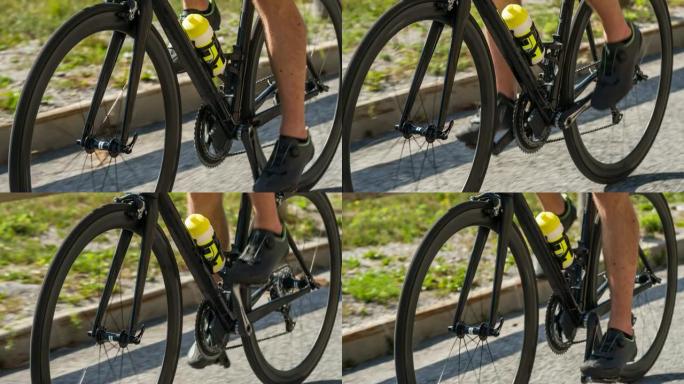 赛车自行车细节，骑自行车的人的腿踩踏板上坡，车轮旋转