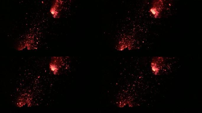 特写: 鲜红色的熔融岩浆碎片从活火山中射出。
