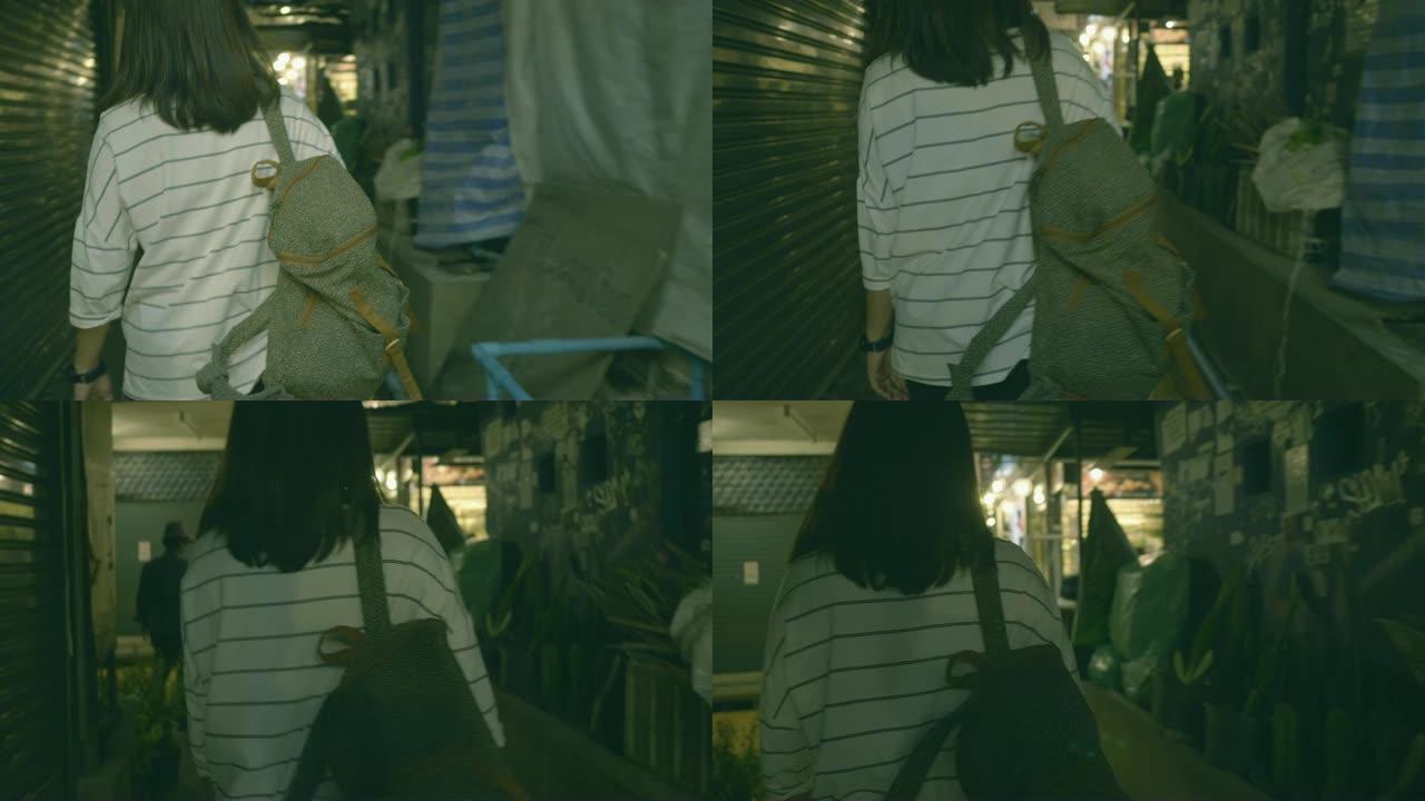 长头发的亚洲女孩在曼谷市场散步