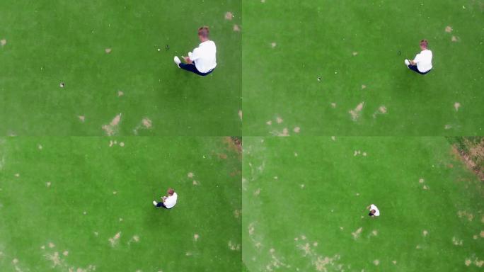 一名男子在球场上打高尔夫球的俯视图
