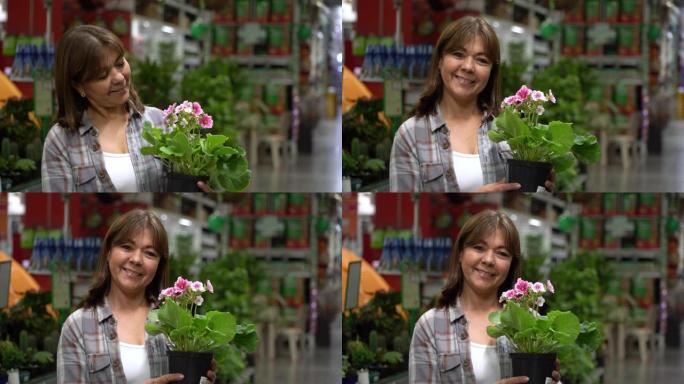 快乐的拉丁美洲妇女在五金店或花园中心购买植物