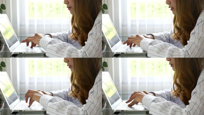 女人在笔记本电脑键盘上打字