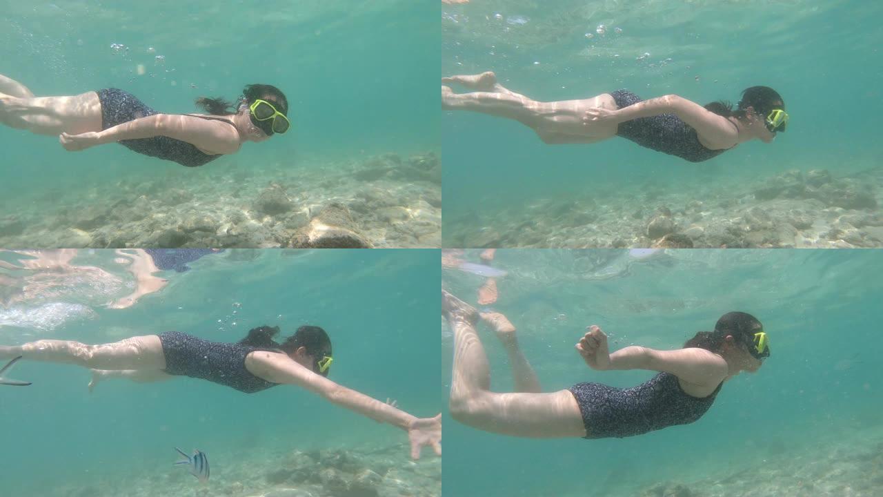 在热带水中浮潜的年轻女子