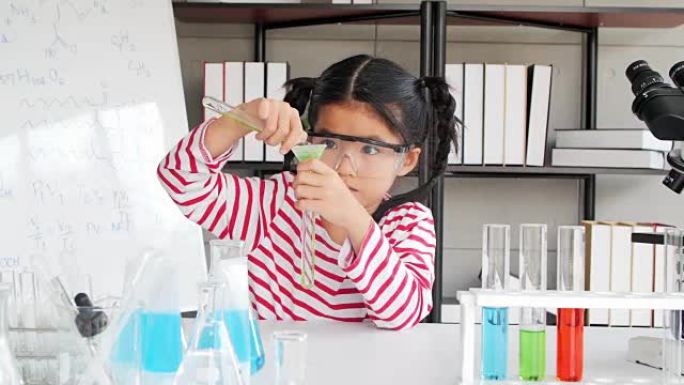 教育主题: 有趣的小女孩在实验室做实验。科学与教育。