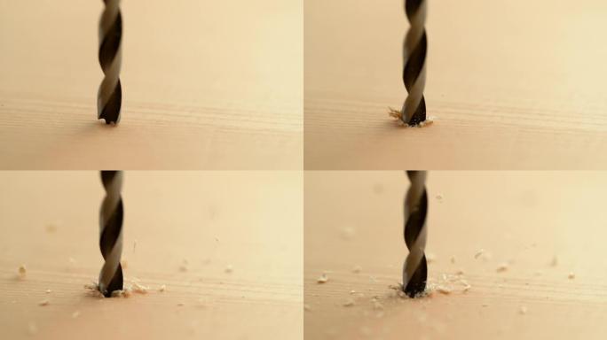 宏观: 锋利的金属钻头在木板上钻孔的详细镜头。