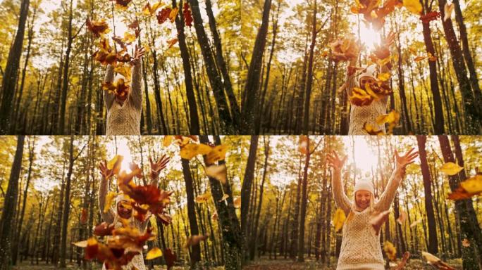 MS超级慢动作肖像无忧无虑的年轻女子在森林里扔金色的秋叶