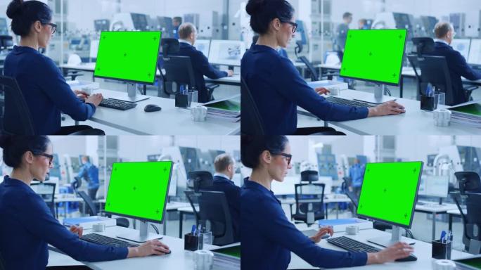 在肩膀上: 在个人计算机上工作的女总工程师，显示为绿色模型屏幕或色键。拥有高科技机械和专业工人的工业