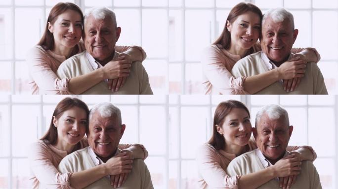 快乐成长的孙女拥抱老年人的拥抱表情和相机。