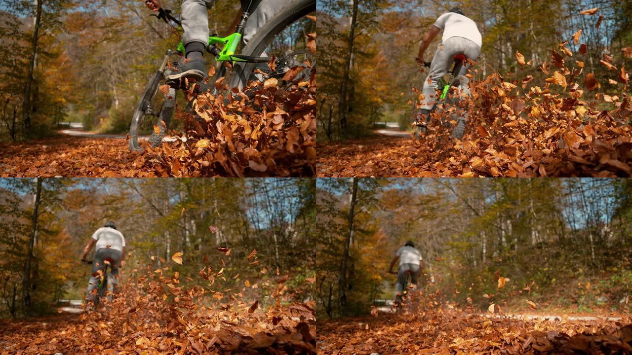特写: 面目全非的人骑着山地自行车进入一堆落叶