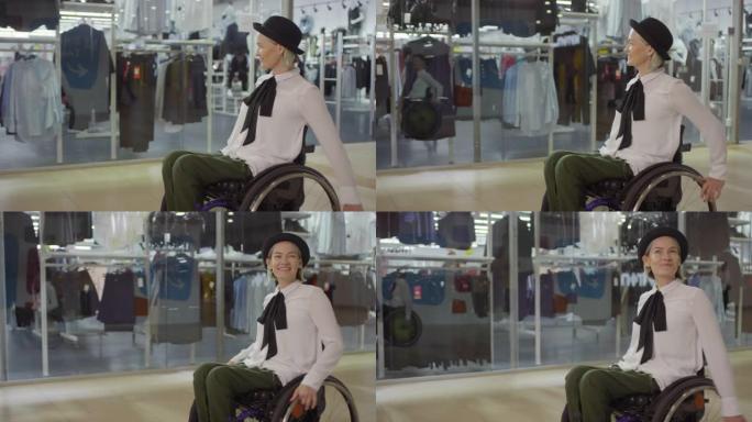 坐在轮椅上的快乐残疾妇女穿过购物中心