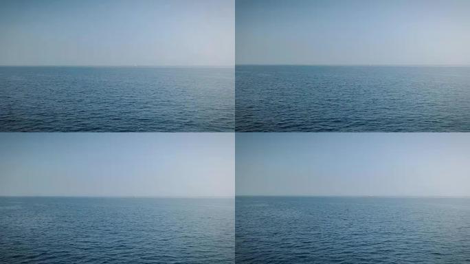 无人机的鸟瞰图是平静的蓝色大海，没有波浪，但清澈而晶莹剔透。