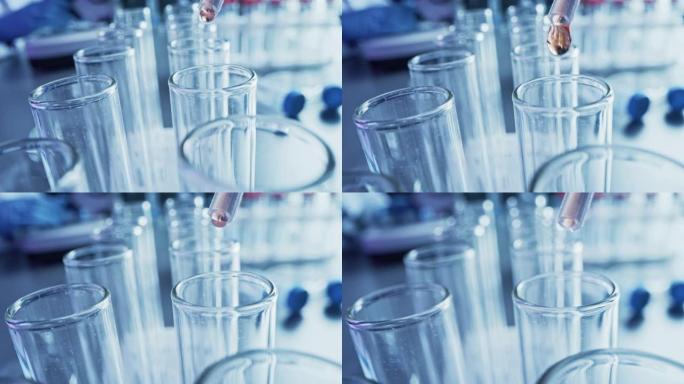 药剂学实验室: 移液器将液体滴入试管，医学研究和分析。科学实验室; 滴管用用于DNA研究的生化流体填