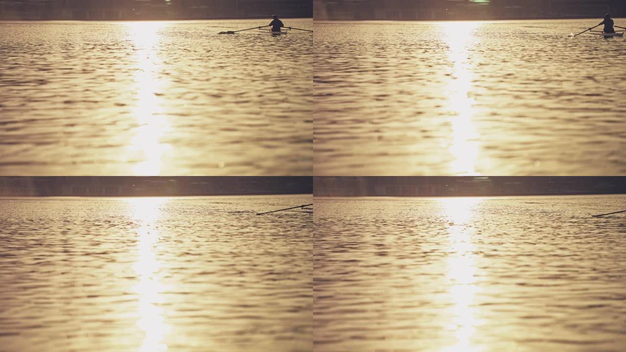 日落期间，男子在河上划桨船