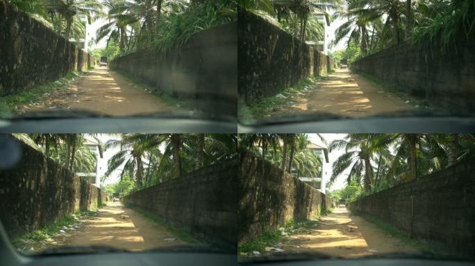 MS汽车沿着斯里兰卡阳光明媚的土路小巷行驶