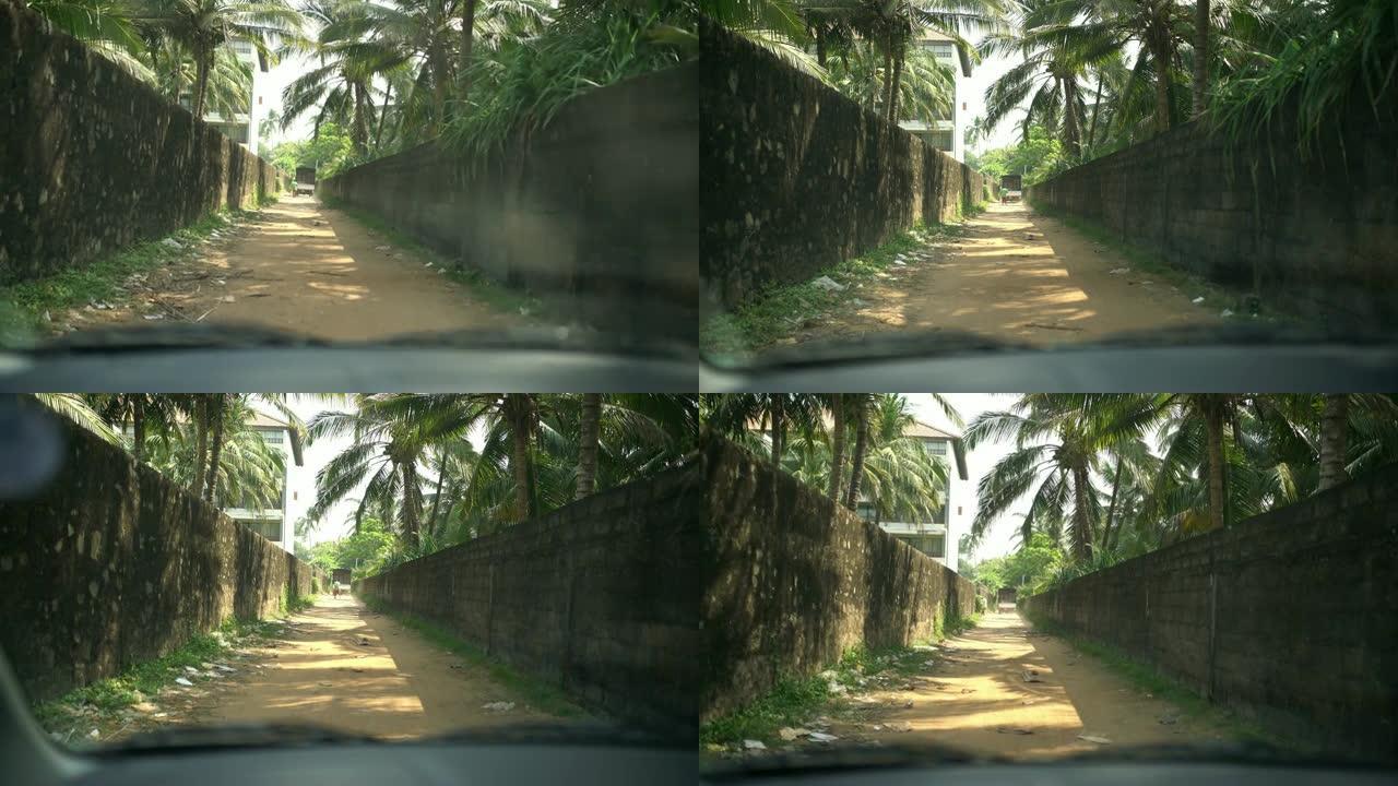 MS汽车沿着斯里兰卡阳光明媚的土路小巷行驶