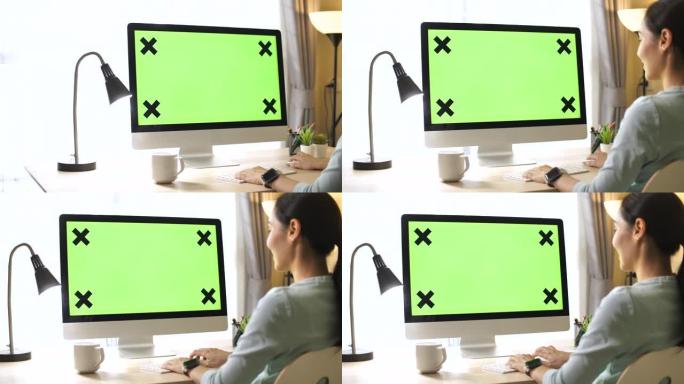 女人使用绿屏电脑居家办公绿屏通话打字联网