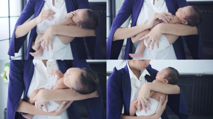 商业母亲抱着熟睡的男婴