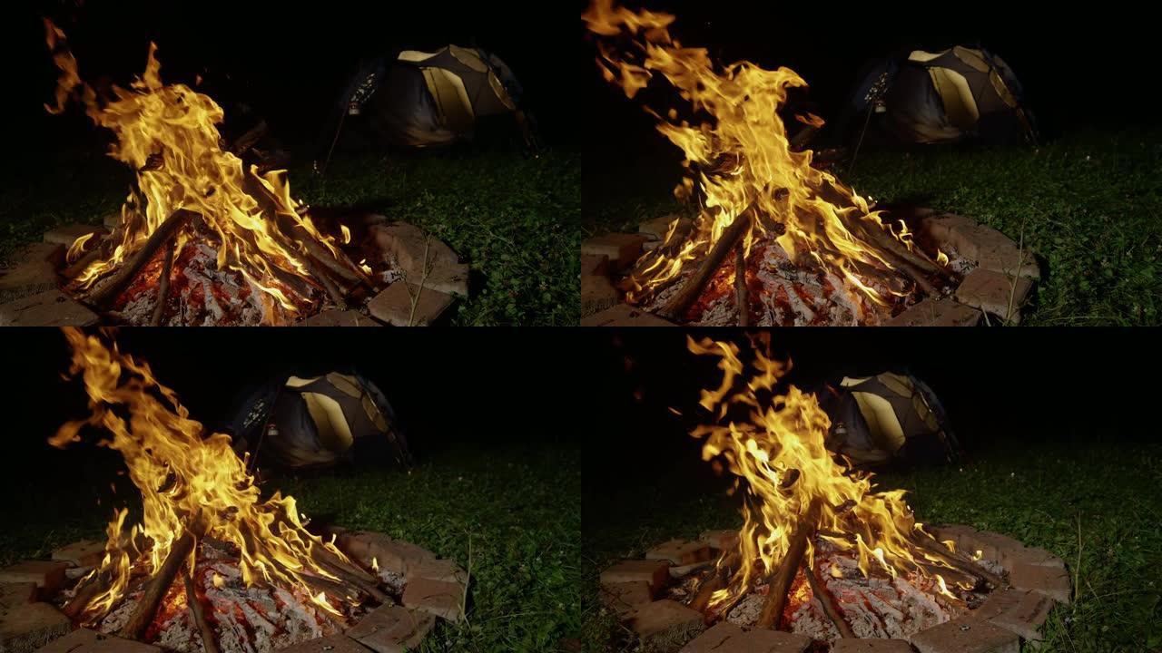 慢动作: 篝火在火坑内燃烧，照亮营地。