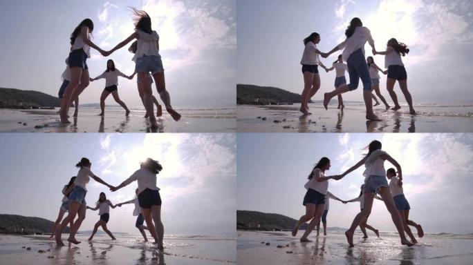 SLO MO一群女性朋友在日落海滩玩得开心。海滩假期旅游概念