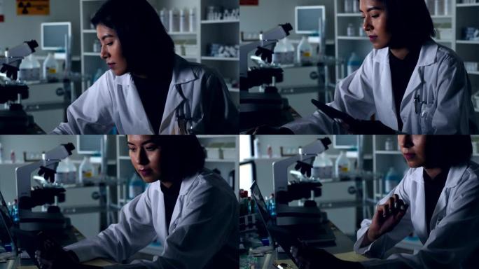 女科学家在实验室中使用数字平板电脑
