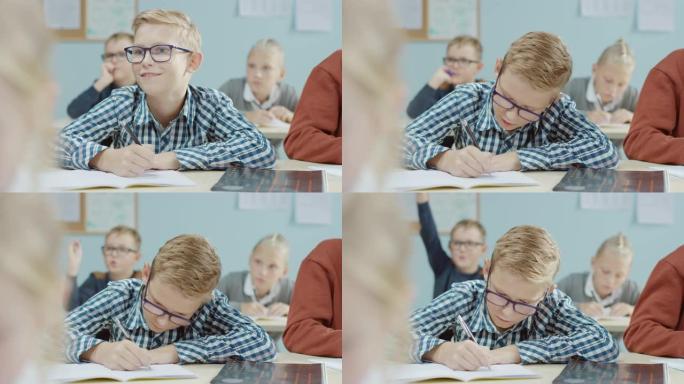 在小学课堂上: 一个戴着眼镜的才华横溢的高加索男孩的肖像写在练习笔记本上。不同群体的聪明儿童学习科学