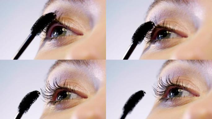 女人将睫毛膏涂在眼睛上，以制作最佳妆容，并突出眼睛的颜色和特征。
