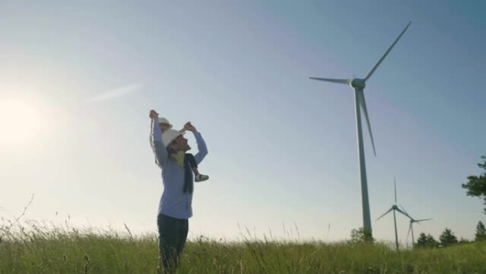 一位父亲工程师，将女儿抱在怀里，自由地在风力涡轮机之间奔跑。
