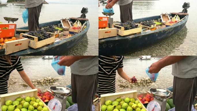男子女士在船上向妇女出售新鲜水果