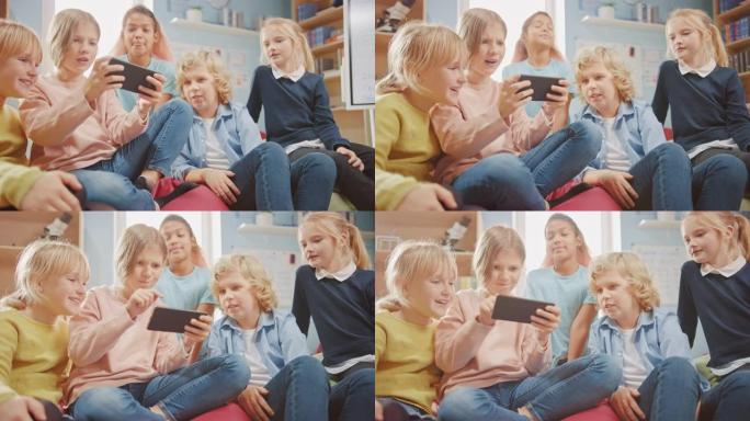 孩子们在互联网上浏览，在手机上玩在线视频游戏，看视频。一群可爱的小孩坐在一起的豆袋上，使用智能手机聊