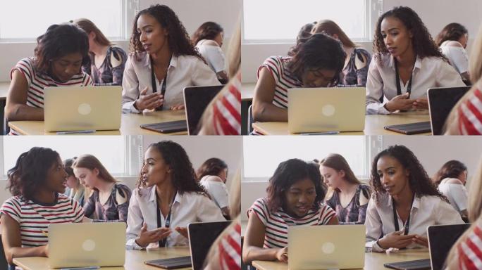 女教师为在笔记本电脑上工作的女学生提供一对一的支持