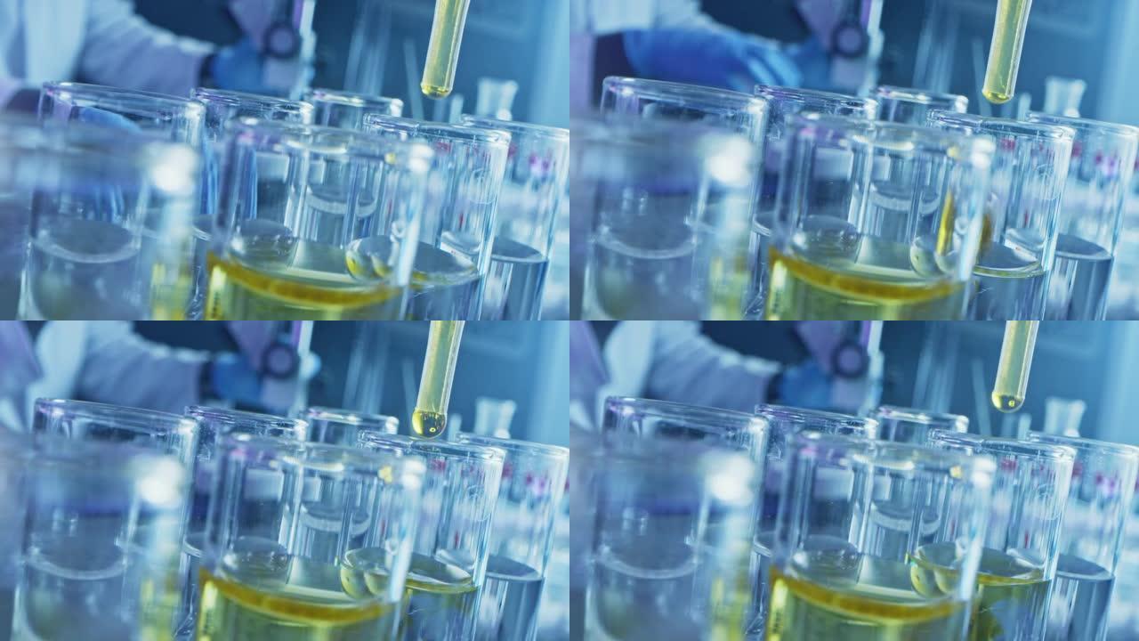 药剂学实验室:用移液管将黄色液体滴入试管，医学研究，分析。科学实验室;滴管灌装样品管创新DNA研究溶
