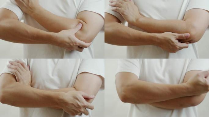 穿着白衬衫的亚洲男人感到肘部疼痛。肌肉疼痛，保健概念。