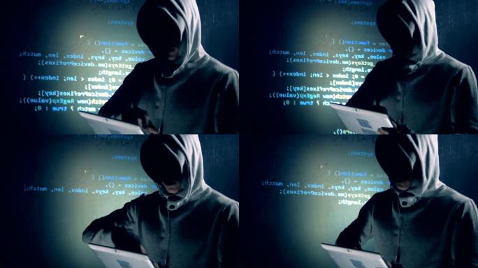 一个骗子在黑客攻击平板电脑的时候，特写。