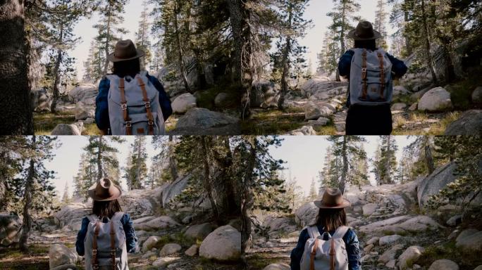 镜头跟随年轻的旅游女孩独自背着背包在优胜美地国家公园的美丽岩石上徒步旅行慢动作
