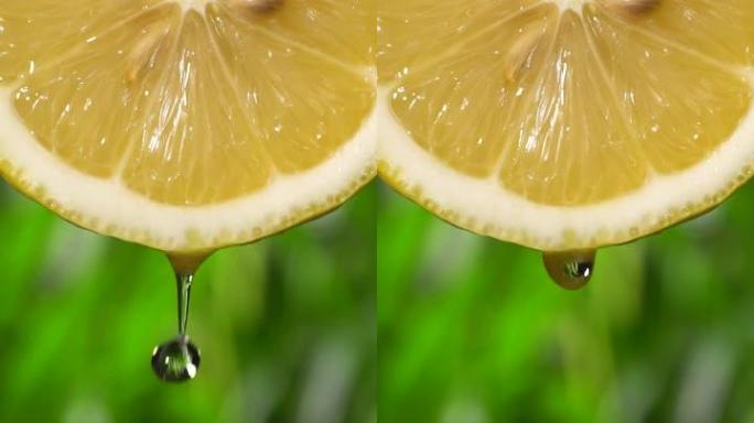 垂直和慢动作: 绿色bokeh上柠檬片中的许多液体掉落