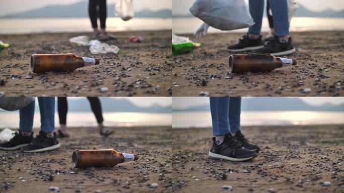 年轻女子在海滩上捡瓶子的特写镜头