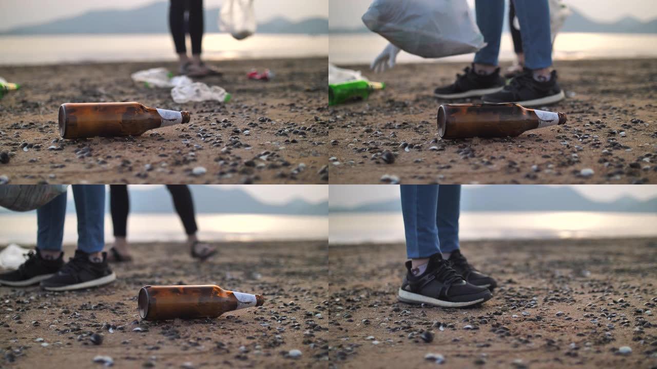 年轻女子在海滩上捡瓶子的特写镜头