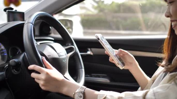 驾驶汽车时在汽车中使用智能手机的女人