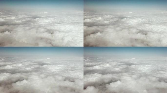通过商用飞机的机舱窗户观察空中的云景