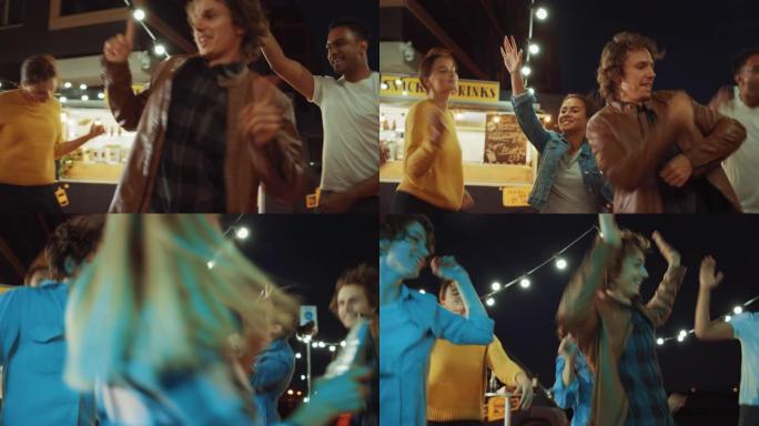 一群朋友正在街头食品汉堡咖啡馆外面举行聚会。他们跳舞并转向时尚音乐。今天是在一个现代凉爽的街区的夜晚