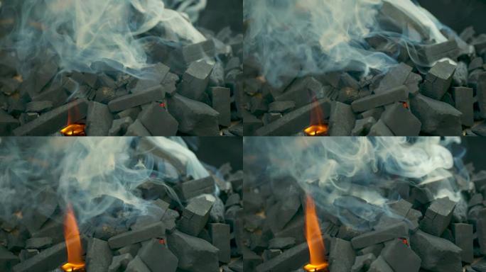 慢动作在火盆烧烤架中燃烧煤炭