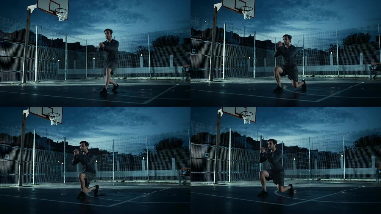 穿着运动服的强壮肌肉健康的年轻人做向前的弓步练习。他正在一个有围栏的室外篮球场里锻炼身体。居民区下雨