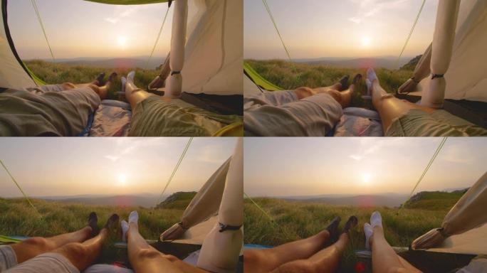 太阳耀斑: 年轻夫妇在帐篷里看日落时移动脚