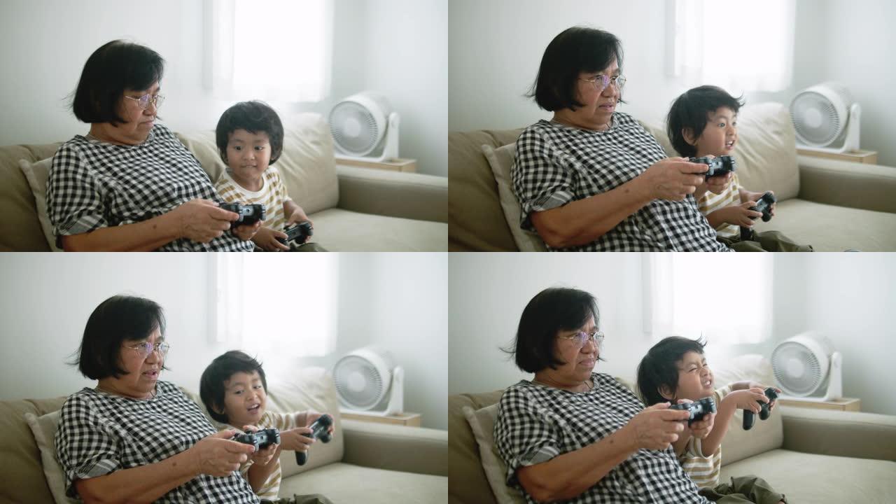 兴奋的男孩在家里与祖母竞争电子游戏