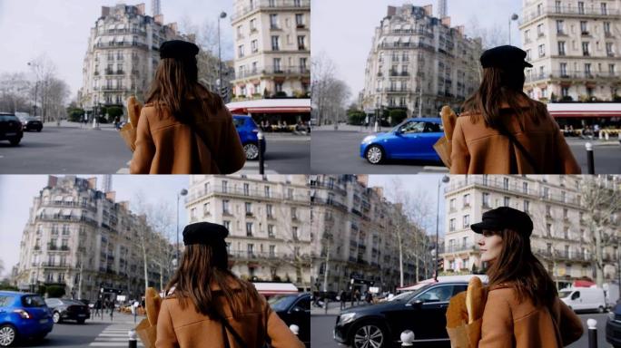 美丽快乐的旅游女人带着纸购物袋慢动作沿着繁忙的巴黎街散步。