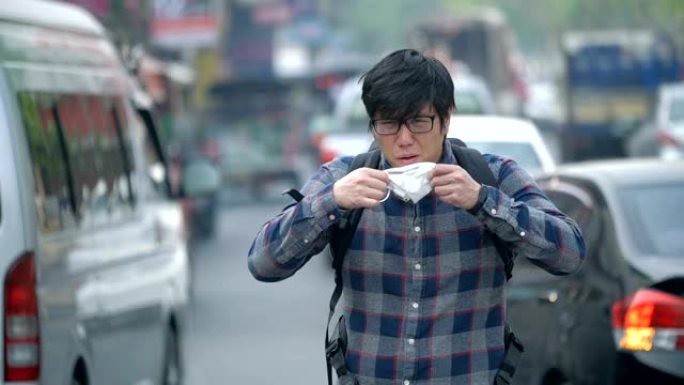 SLO MO咳嗽亚洲男子在交通中戴空气污染口罩